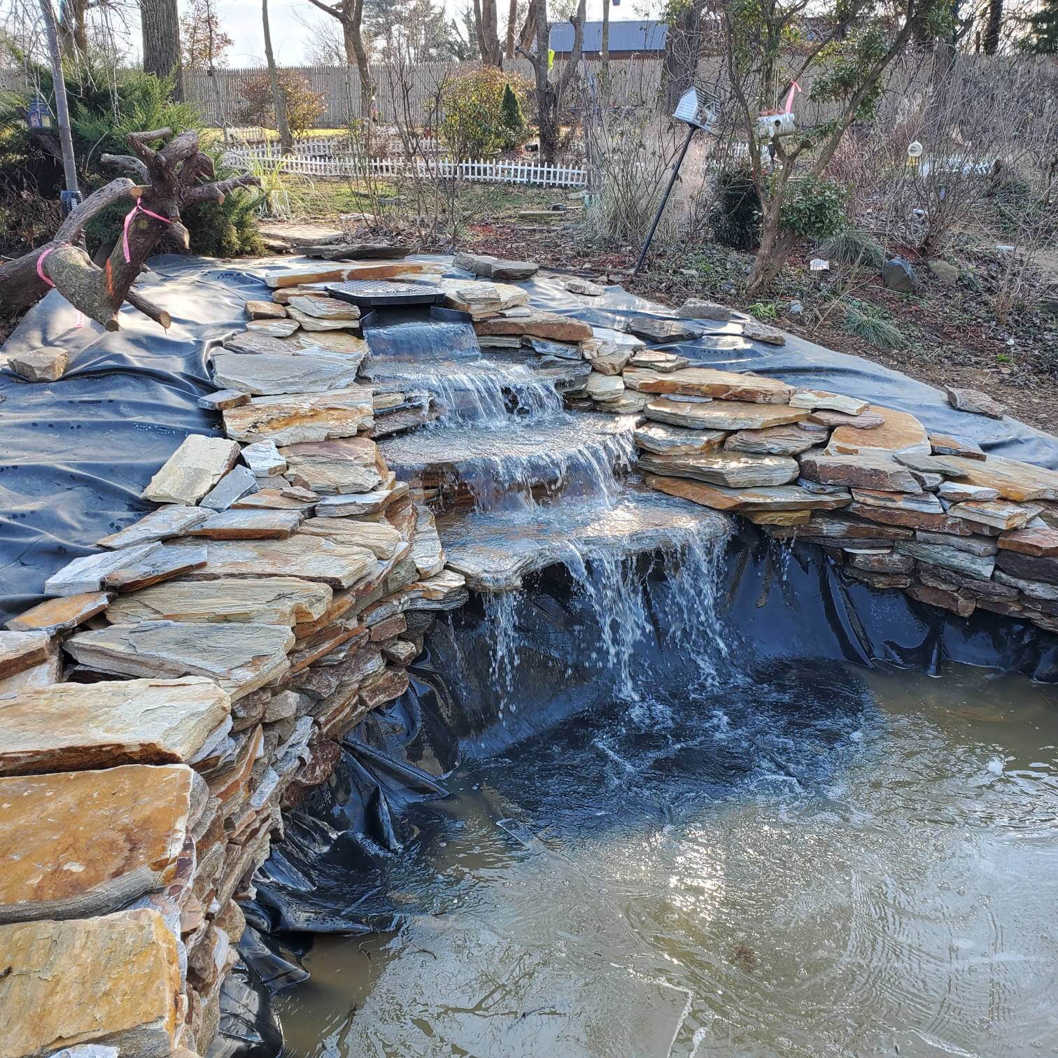 Outdoor backyard waterfall with cascading water