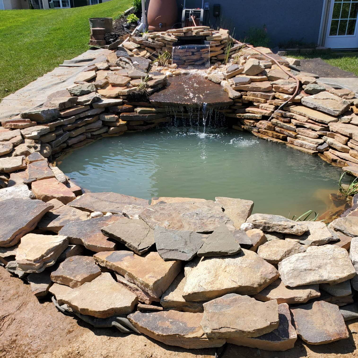 Backyard pond creating a serene environment in a Delaware backyard